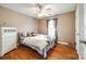 Cozy bedroom with white bedding, hardwood floors, white dresser and natural light at 5664 Norwood Ridge Dr, Rock Hill, SC 29732