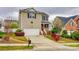 Charming two-story home featuring an attached garage and well-manicured front yard landscaping at 5664 Norwood Ridge Dr, Rock Hill, SC 29732