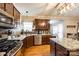 Spacious kitchen features granite countertops, stainless appliances, hardwood floors and modern lighting at 5664 Norwood Ridge Dr, Rock Hill, SC 29732