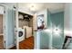 Well-organized laundry room with washer, dryer, and built-in shelving for storage at 5664 Norwood Ridge Dr, Rock Hill, SC 29732