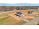 Wide aerial shot of two pristine homes in a spacious, natural landscape, showcasing a serene and open environment at 603 Mt. Wesley Church Rd, Hiddenite, NC 28636