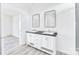 Bathroom featuring dual sinks and modern mirrors and access to a second room at 603 Mt. Wesley Church Rd, Hiddenite, NC 28636