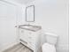 A well-lit bathroom with a vanity, granite countertop, and toilet at 603 Mt. Wesley Church Rd, Hiddenite, NC 28636