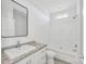 Bright bathroom featuring a vanity with granite countertop and a shower/tub combo at 603 Mt. Wesley Church Rd, Hiddenite, NC 28636
