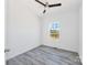 Bright bedroom featuring a ceiling fan, window, and stylish gray wood-look flooring at 603 Mt. Wesley Church Rd, Hiddenite, NC 28636