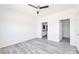 A bright bedroom with light gray wood-look floors that leads to an ensuite bathroom at 603 Mt. Wesley Church Rd, Hiddenite, NC 28636
