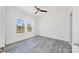 Well-lit bedroom showcasing light gray flooring and a pair of windows offering a backyard view at 603 Mt. Wesley Church Rd, Hiddenite, NC 28636