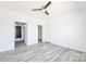 Spacious bedroom showing bathroom and closet access, plus modern flooring and neutral decor at 603 Mt. Wesley Church Rd, Hiddenite, NC 28636