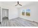 Bedroom with light gray floors, ceiling fan, and view into an adjacent room at 603 Mt. Wesley Church Rd, Hiddenite, NC 28636