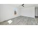 Bright bedroom with modern gray floors, a ceiling fan, and a window at 603 Mt. Wesley Church Rd, Hiddenite, NC 28636
