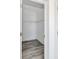 A walk-in closet with modern, gray wood flooring and white shelving at 603 Mt. Wesley Church Rd, Hiddenite, NC 28636