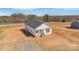 Inviting white home featuring a classic design with a covered porch and ample space for outdoor activities at 603 Mt. Wesley Church Rd, Hiddenite, NC 28636