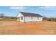 Elegant white home with simple window design and landscaping on a flat terrain with ample surrounding open space at 603 Mt. Wesley Church Rd, Hiddenite, NC 28636