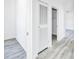 Bright hallway with gray wood-look floors, white walls, and closet at 603 Mt. Wesley Church Rd, Hiddenite, NC 28636