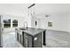 Bright, open kitchen with stainless appliances and island open to an airy living room with large windows at 603 Mt. Wesley Church Rd, Hiddenite, NC 28636