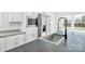 Modern kitchen with stainless steel appliances, granite countertops, and a sink with a flexible faucet at 603 Mt. Wesley Church Rd, Hiddenite, NC 28636