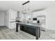 Beautiful white kitchen with stainless steel appliances, gray countertops, and an island with black cabinetry at 603 Mt. Wesley Church Rd, Hiddenite, NC 28636