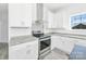 White kitchen with stainless steel appliances and granite countertops at 603 Mt. Wesley Church Rd, Hiddenite, NC 28636