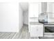 Open concept kitchen with gray wood-look floors and stainless appliances at 603 Mt. Wesley Church Rd, Hiddenite, NC 28636