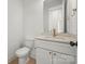 Modern bathroom featuring a sink, white cabinets, and a toilet at 605 Arrow Point Ln, Davidson, NC 28036