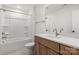 Clean bathroom features a tub-shower combo and white countertops with a wood vanity at 605 Arrow Point Ln, Davidson, NC 28036
