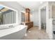 Luxurious bathroom featuring a soaking tub, double vanity, tile floors, and a glass shower at 605 Arrow Point Ln, Davidson, NC 28036