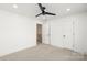 Bright bedroom featuring neutral carpet, a ceiling fan, a door and a closet at 605 Arrow Point Ln, Davidson, NC 28036