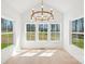 Elegant dining room bathed in natural light, featuring a modern chandelier and an expansive view of the outdoors at 605 Arrow Point Ln, Davidson, NC 28036