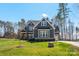 Charming two-story home featuring a well-manicured lawn, architectural shingles, and a seamless side-entry two-car garage at 605 Arrow Point Ln, Davidson, NC 28036