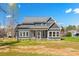 Striking two-story home featuring gray siding, a gray roof, and a well-manicured lawn at 605 Arrow Point Ln, Davidson, NC 28036