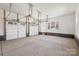 Spacious two car garage with windows, white walls, and brick baseboards at 605 Arrow Point Ln, Davidson, NC 28036
