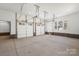 Spacious two car garage with windows, white walls, and brick baseboards at 605 Arrow Point Ln, Davidson, NC 28036