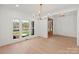 Sunlit living room boasting large windows, hardwood flooring, and neutral decor at 605 Arrow Point Ln, Davidson, NC 28036