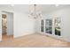 Bright room featuring large windows, hardwood flooring, and neutral decor at 605 Arrow Point Ln, Davidson, NC 28036