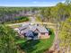 Aerial view of a luxury home featuring a long driveway, circular motor court, and lush landscaping at 6422 Chimney Bluff Rd, Lancaster, SC 29720