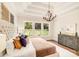Charming bedroom with a tray ceiling, hardwood floors, and bright windows at 6422 Chimney Bluff Rd, Lancaster, SC 29720