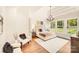 Bright bedroom features a tray ceiling, large windows, and neutral decor at 6422 Chimney Bluff Rd, Lancaster, SC 29720