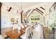 Dining room features hardwood flooring, a table with upholstered chairs, modern chandelier, and wood beam accents at 6422 Chimney Bluff Rd, Lancaster, SC 29720