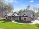 Beautiful single-story home with stone accents, manicured lawn, and mature trees at 6422 Chimney Bluff Rd, Lancaster, SC 29720