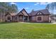 Beautiful front lawn of a home with stone accents and mature trees at 6422 Chimney Bluff Rd, Lancaster, SC 29720