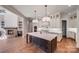 Modern kitchen with a large island, pendant lights, white cabinets, and stainless steel appliances at 6422 Chimney Bluff Rd, Lancaster, SC 29720