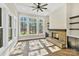 Cozy living room featuring a brick fireplace and large windows at 6422 Chimney Bluff Rd, Lancaster, SC 29720