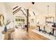 Spacious living room with high ceilings, wood beams, large windows, and hardwood floors at 6422 Chimney Bluff Rd, Lancaster, SC 29720