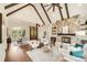 Open-concept living room features a stone fireplace, hardwood floors, beamed ceilings, and ample natural light at 6422 Chimney Bluff Rd, Lancaster, SC 29720