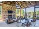 Cozy outdoor lounge area with stone fireplace, TV, and comfortable seating at 6422 Chimney Bluff Rd, Lancaster, SC 29720