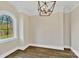 Well-lit room with dark hardwood floors, white walls, and decorative lighting at 6422 Chimney Bluff Rd, Lancaster, SC 29720