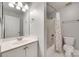 Well-lit bathroom featuring a tub and shower combo, floral shower curtain, and modern fixtures at 6804 Riesman Ln, Charlotte, NC 28210