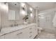 Bright bathroom with double sink vanity, marble countertops, and glass enclosed shower at 6804 Riesman Ln, Charlotte, NC 28210