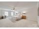 Spacious primary bedroom with large windows, ceiling fan, and neutral tones at 6804 Riesman Ln, Charlotte, NC 28210