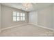 Bright bedroom with neutral walls, carpet, and plantation shutters at 6804 Riesman Ln, Charlotte, NC 28210